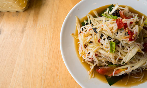 istock papaya salad on wood table in restaurant. 636056338