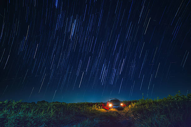 istock night scene of star tail and blue sky over car 636057888