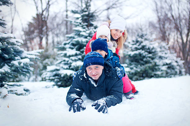 istock Attractive family having fun in a winter park 636057898
