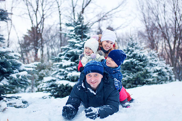 istock Attractive family having fun in a winter park 636058072