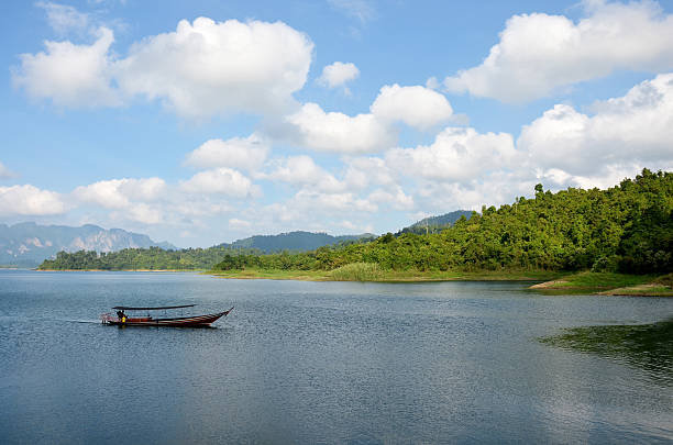 istock Thai people sail long tail boat in Cheow Lan Lake 636060364