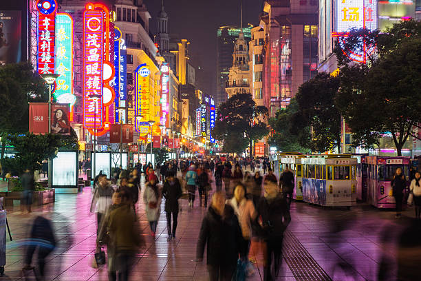 Crowd in Nanjing Road Night view of Nanjing Road in Shanghai. chinese ethnicity stock pictures, royalty-free photos & images