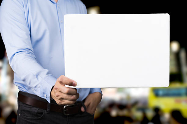 istock businessman showing blank signboard with copy space area and Cit 636071284