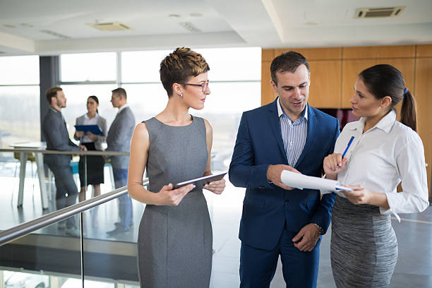 istock Three business people discussing business strategy using digital tablet 636071418