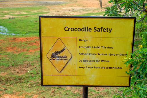 Beware of crocodiles. Caution plate alerting about dangerous predators in water