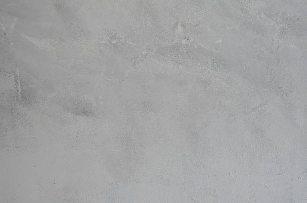 istock Gray plaster weathered wall with stains and cracks 636072662