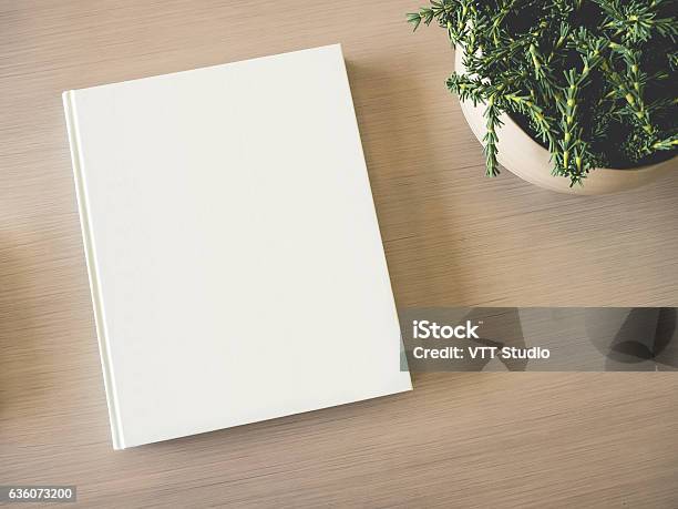 Mock Up White Book Cover On Table With Green Plant Stock Photo - Download Image Now - Book, Template, Book Cover