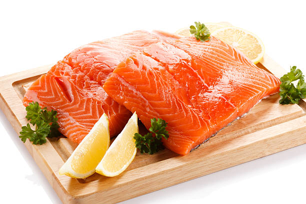 istock Fresh raw salmon fillet on cutting board on white background 636074270