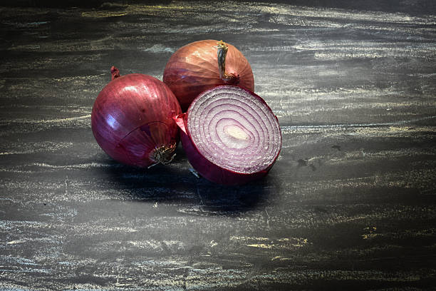 istock Red onion on black background. Organic food. 636075532
