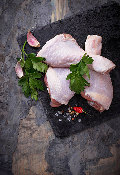 istock Raw chicken legs with parsley 636075576