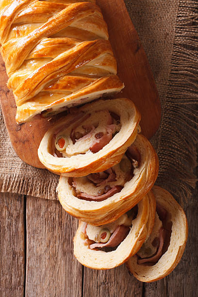 istock Venezuelan bread pan de jamon close-up on the table. Vertical 636078286