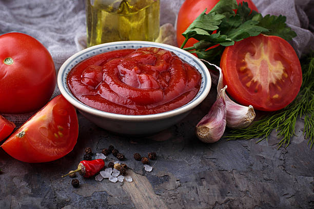 istock Tomato ketchup sauce on concrete background 636078348