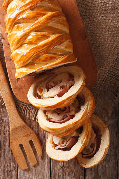 istock Venezuelan cuisine: Christmas loaf pan de jamon close-up. Vertical 636078466