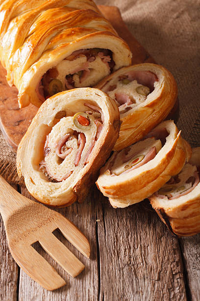 istock Venezuelan ham bread with olives and raisins close-up. vertical 636079302