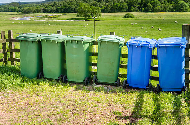istock Recycling Bins along a Fence 636079392