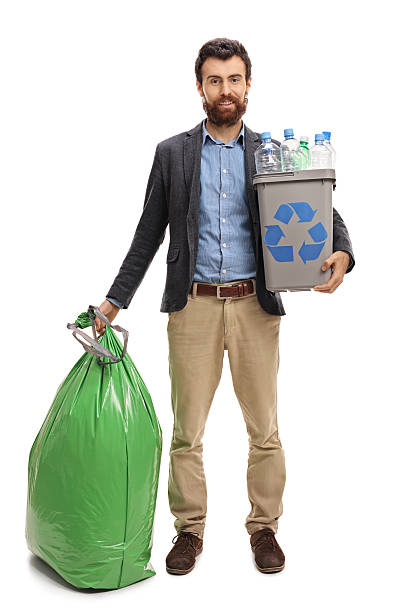 istock Man with a recycling bin and a garbage bag 636079446