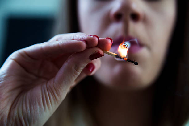 istock young girl with a cigarette in her hand 636080692
