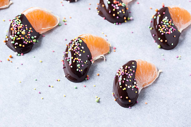 istock mandarine, tangerine fruits covered chocolate 636081588