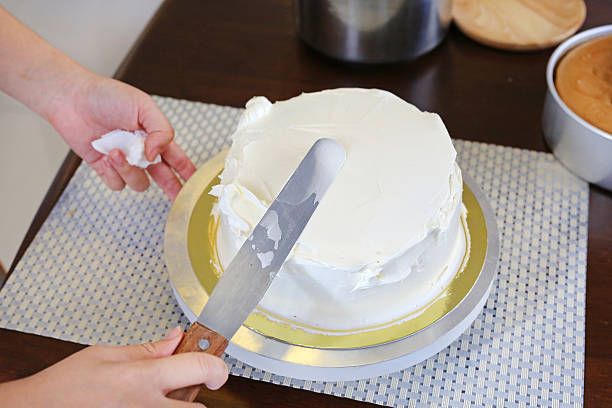 istock Cake in process on stand on wooden table, Homemade Cake. 636081812