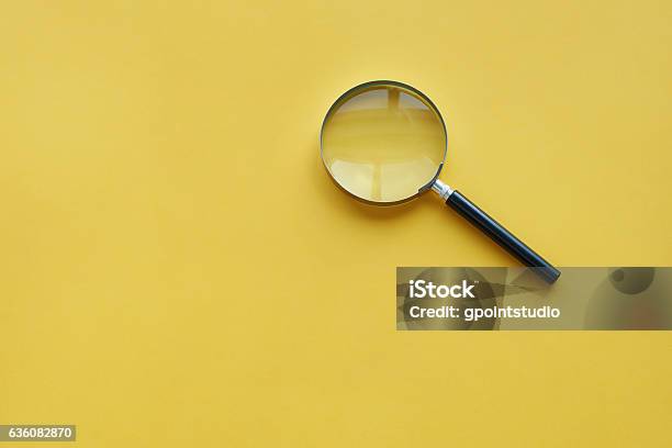 Magnifying Glass On The Orange Background Stock Photo - Download Image Now - Magnifying Glass, Colored Background, Curiosity
