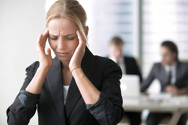 istock Young businesswoman with headache 636083180