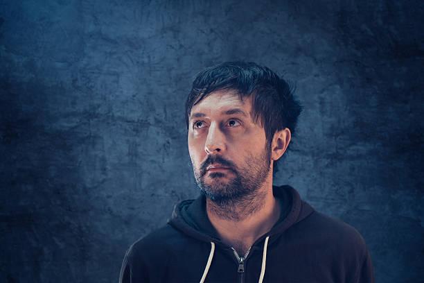 istock Confused man with so many questions looking up 636088178