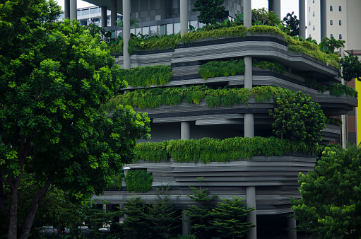 Modern skyscraper wall with green plants terraces