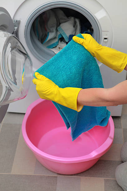 istock woman taking color clothes 636090110