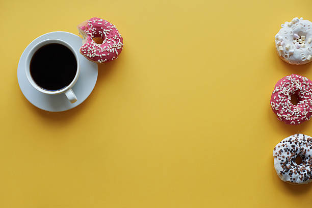 istock Four sprinkled dontus and cup of coffee 636095858