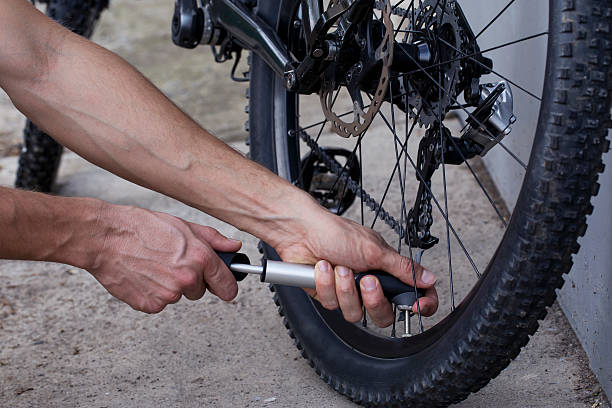 istock The young man inflates bicycle wheel 636096182