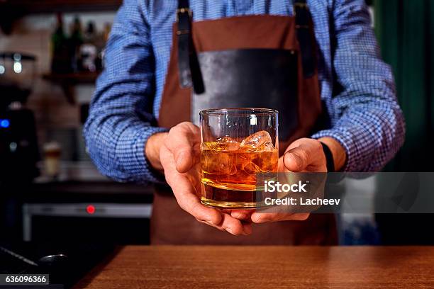 Hands Of A Bartender At Bar Restaurant With Glass Whiskey Stock Photo - Download Image Now