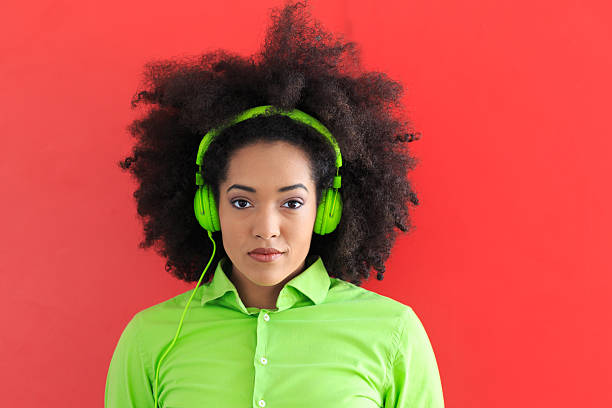 istock Young woman with green headset looking at camera 636097276