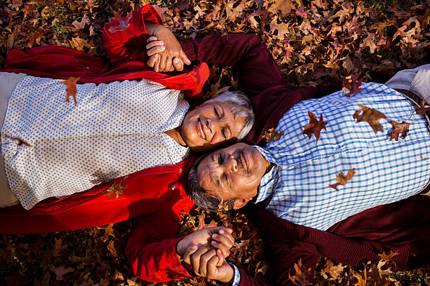 istock Mature couple relaxing at park during autumn 636097770
