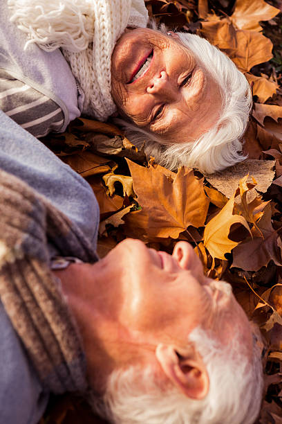 istock Senior couple lying on the ground 636099038