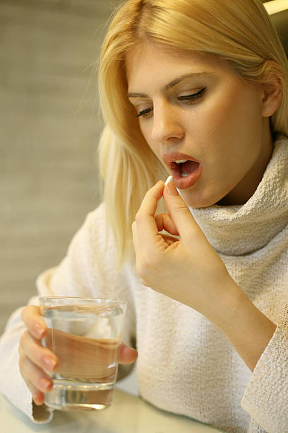 istock Woman taking a pill. 636099386