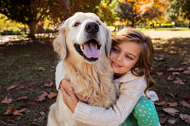 istock Little girl embracing her dog 636099584
