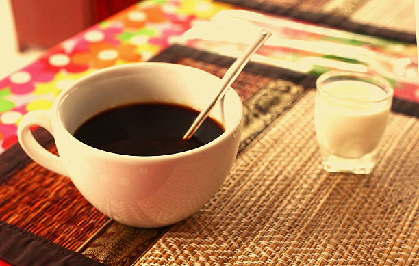 istock cup of cofe and cream on bamboo mat 636100062