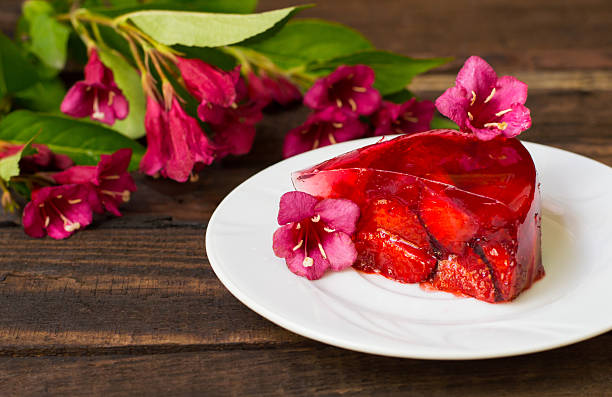 istock Jelly with strawberries. On a wooden rustic background. Close-up 636100792
