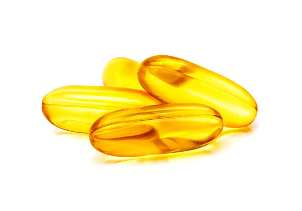istock Fish oil supplement capsule isolated on white background 636100970