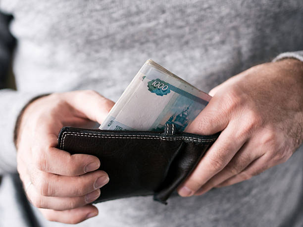 Hands take out russian rubles from wallet stock photo