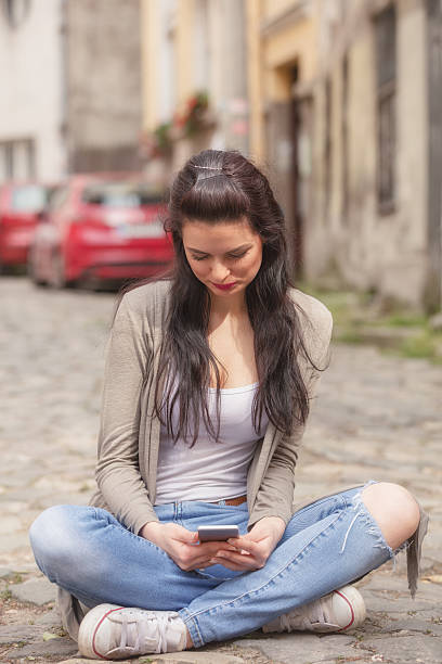 istock Girl using cellphone outdoors. 636102378