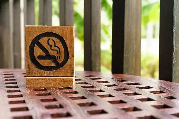 non-smoking sign on wooden table