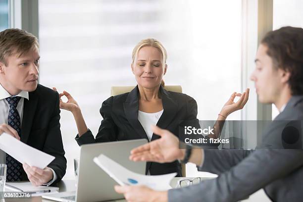 Business Negotiation Men Arguing Woman Meditating Stock Photo - Download Image Now