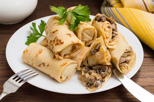 istock Pancakes stuffed with mushrooms and sour cream on a rustic 636104138
