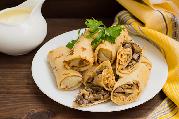 istock Pancakes stuffed with mushrooms and sour cream on a rustic 636104224