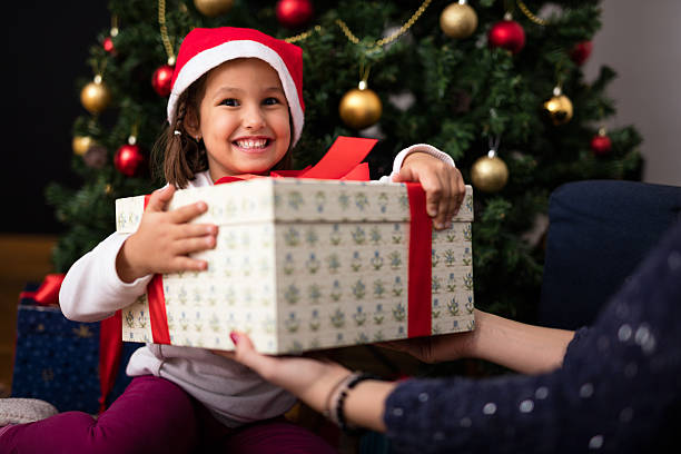 istock Happy smiling girl is holding her present 636105154