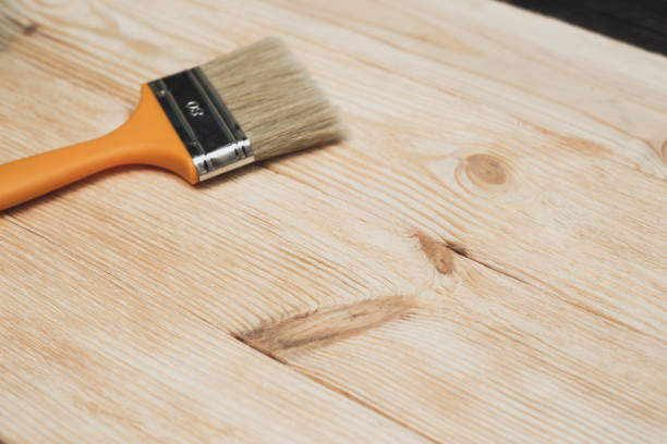 istock Brushed wooden surface with a brush lying on the background 636115596