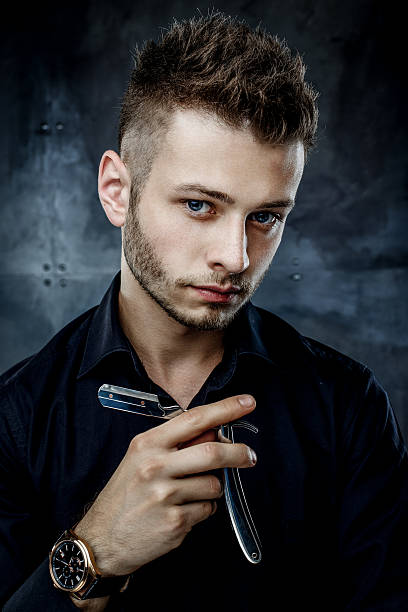 istock Brutal man with straight razor 636117252