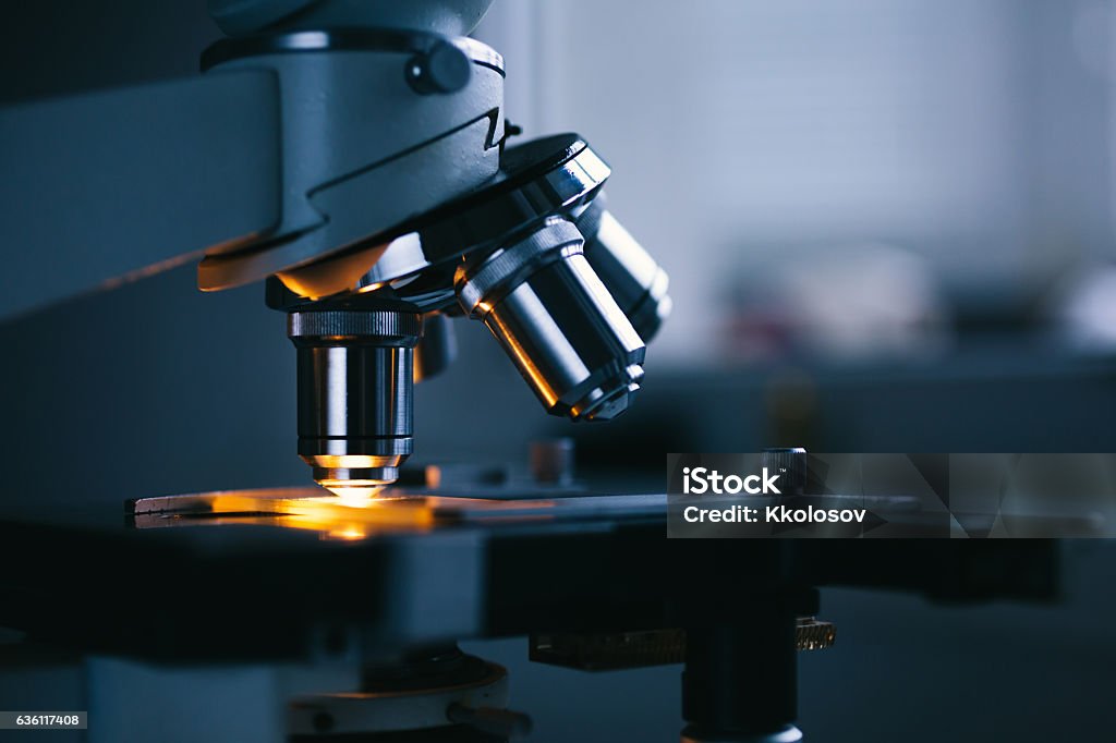 Close up of microscope and test sample Close up of examining of test sample under the microscope in laboratory. Medical Test Stock Photo