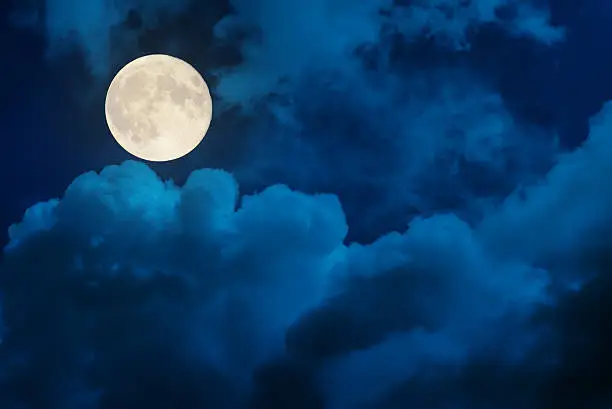 supermoon in dramatic clouds